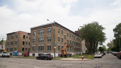 An older brick apartment building in the midst of renovations