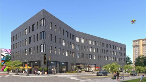 A rendering of a four-story grey apartment building