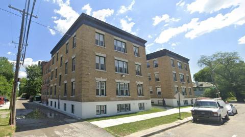 A three-story brick apartment building