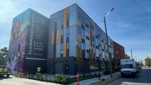 A new 4 story building with a mural and quotes on the side