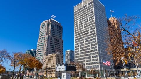 Two light skyscrapers against a blue sky in downtown Detroit