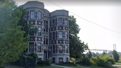A three-story historic brick apartment building