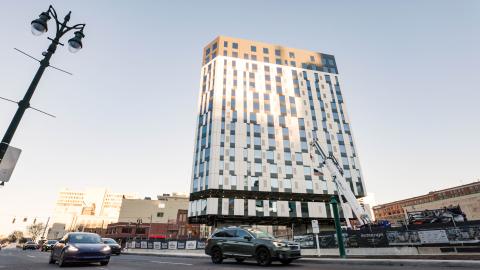 A black and white 16-story building under construction