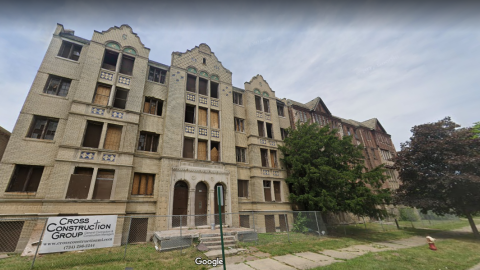 Two vacant brick apartment buildings next to each other on a city block