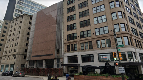 A city block with a non-descript, vacant building in the middle