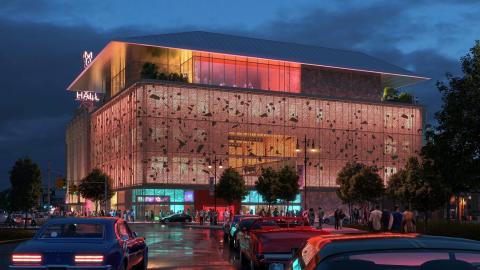 A rendering of a lit up performance hall within a city
